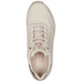 A light beige sneaker with a textured surface displays a lace-up design and a cushioned insole featuring the brand name Skechers prominently embossed on it.