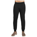 Black jogger pants are being worn by a person standing upright their upper body is not visible the pants fit snugly at the waist and cuffs in a casual setting with casual footwear.