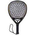 A padel racket features a solid black frame with a textured surface and holes for ball impact the grip has a black textured handle with a wrist strap for secure handling.