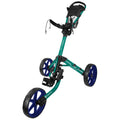 A golf push cart with a teal frame and large blue wheels stands upright. It features a seat for a golf bag and a handle for steering, ideal for use on a golf course.
