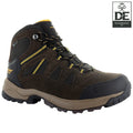 A brown hiking boot with yellow accents is positioned upright showcasing a textured surface and a sturdy sole designed for rugged terrain alongside a logo indicating it as recommended kit.