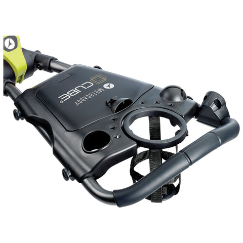 A black and green mobility scooter accessory displays cup holders and a control panel while being positioned for easy access in a user-friendly environment.