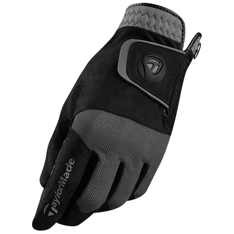 A golf glove is positioned with a sleek design featuring black and gray materials its palm has a smooth finish and the fingers are slightly curved indicating readiness for use in a game.